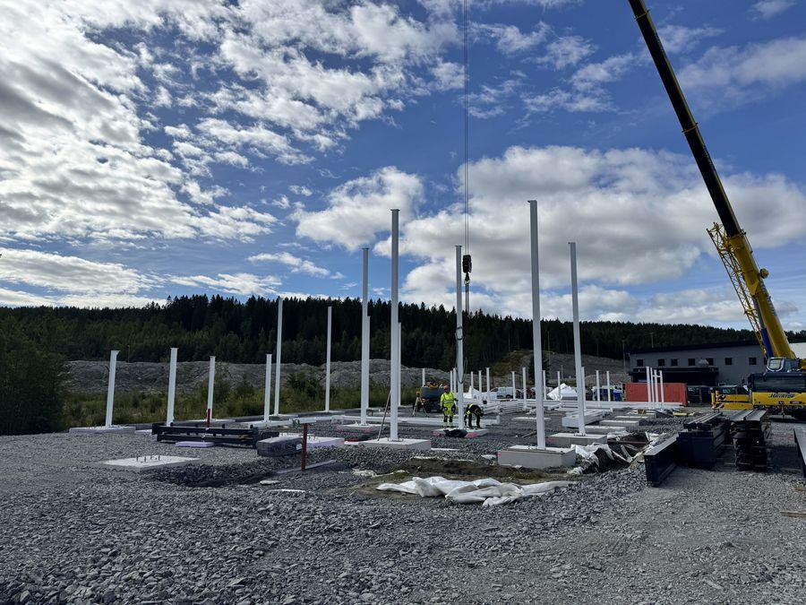 Steel columns set out with mobile crane on site