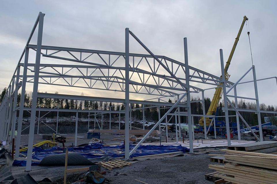 Steel frames and roof trusses of an industrial building with mobile crane